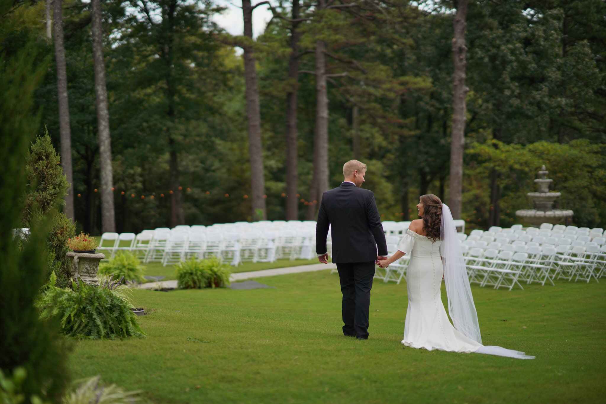 bride and groom holding hands in outdoor wedding ceremony