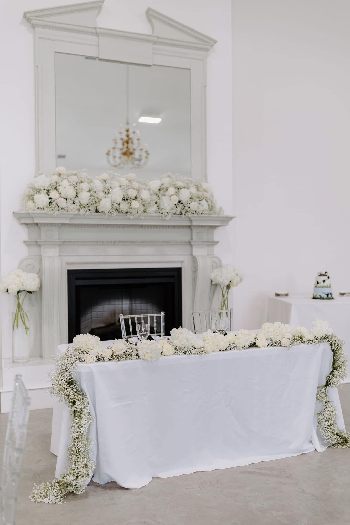 large floral runner on bride and groom's wedding reception table
