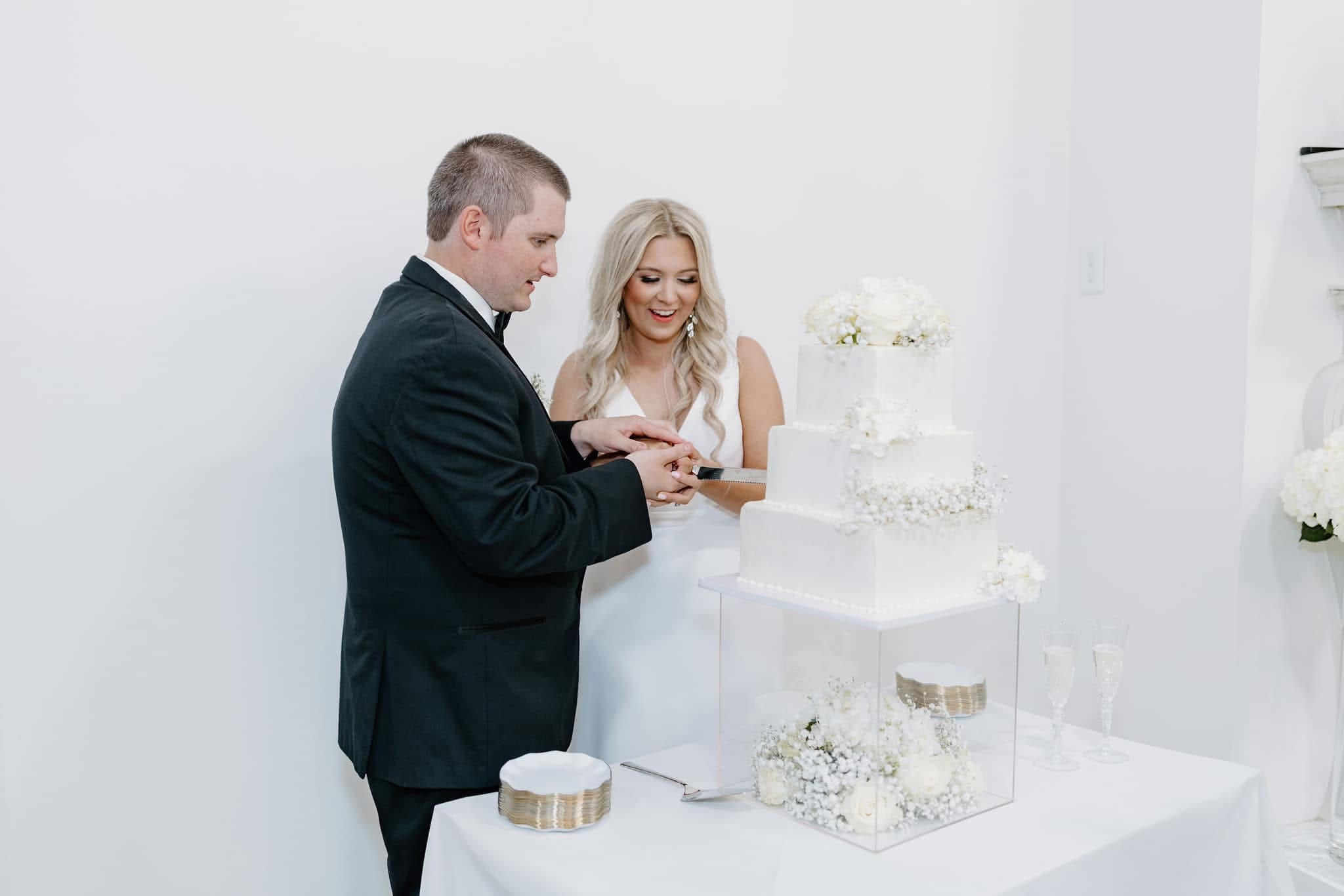 bride and groom cutting cake