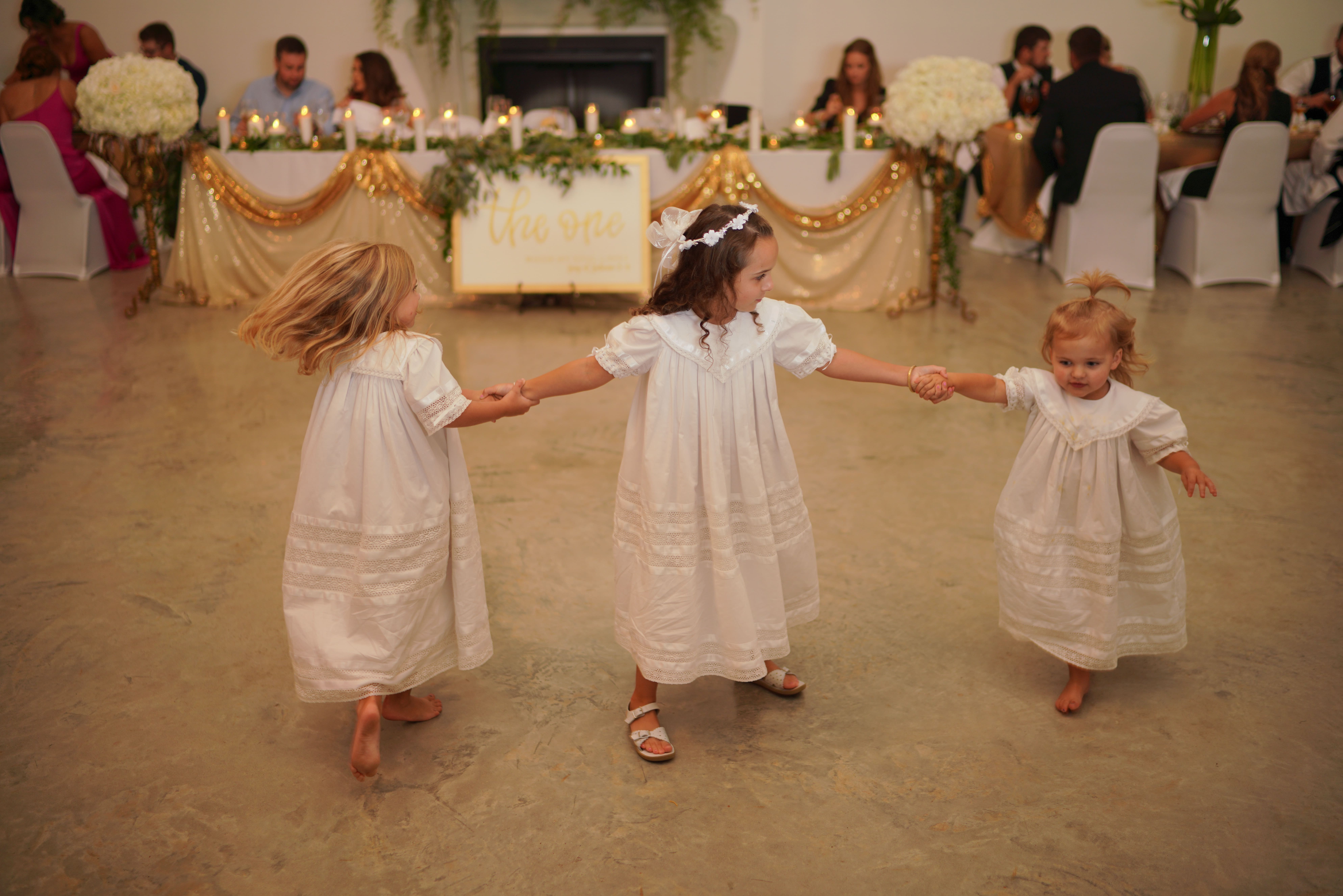 flower girls dancing at wedding reception